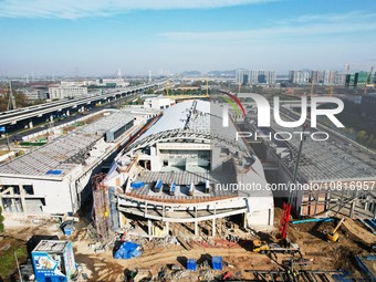 Workers are installing the facade of the experimental building for Zhejiang University's High gravity centrifugal simulation and experimenta...