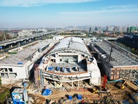 Workers are installing the facade of the experimental building for Zhejiang University's High gravity centrifugal simulation and experimenta...