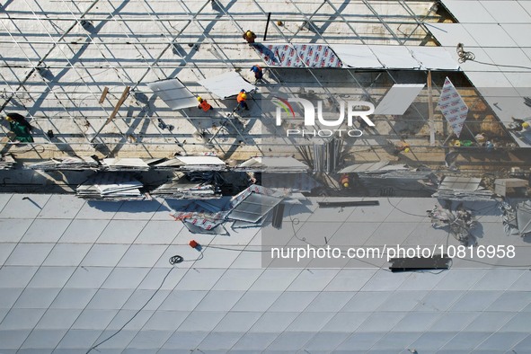 Workers are installing the facade of the experimental building for Zhejiang University's High gravity centrifugal simulation and experimenta...