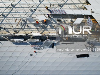 Workers are installing the facade of the experimental building for Zhejiang University's High gravity centrifugal simulation and experimenta...