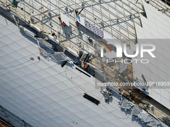 Workers are installing the facade of the experimental building for Zhejiang University's High gravity centrifugal simulation and experimenta...