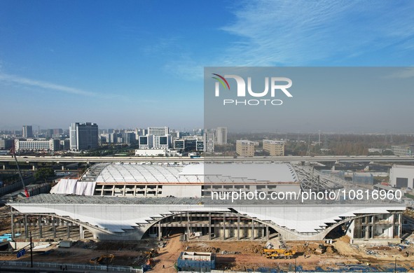 Workers are installing the facade of the experimental building for Zhejiang University's High gravity centrifugal simulation and experimenta...