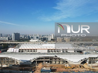 Workers are installing the facade of the experimental building for Zhejiang University's High gravity centrifugal simulation and experimenta...