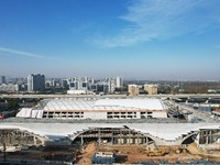 Workers are installing the facade of the experimental building for Zhejiang University's High gravity centrifugal simulation and experimenta...