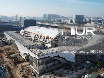 Workers are installing the facade of the experimental building for Zhejiang University's High gravity centrifugal simulation and experimenta...