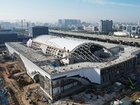 Workers are installing the facade of the experimental building for Zhejiang University's High gravity centrifugal simulation and experimenta...