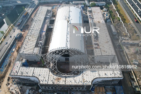 Workers are installing the facade of the experimental building for Zhejiang University's High gravity centrifugal simulation and experimenta...