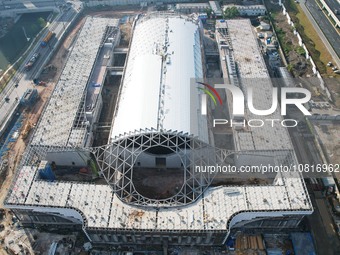 Workers are installing the facade of the experimental building for Zhejiang University's High gravity centrifugal simulation and experimenta...