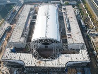 Workers are installing the facade of the experimental building for Zhejiang University's High gravity centrifugal simulation and experimenta...