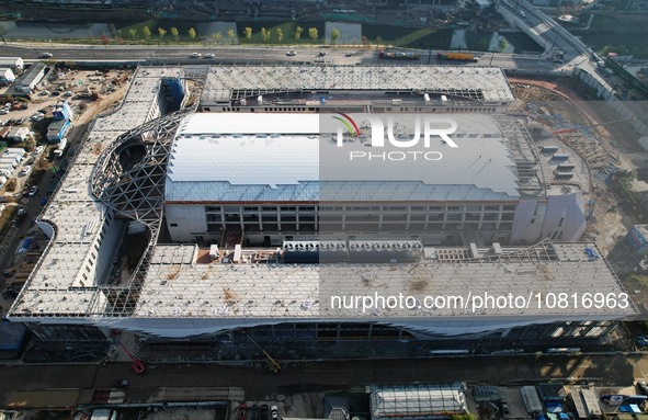 Workers are installing the facade of the experimental building for Zhejiang University's High gravity centrifugal simulation and experimenta...