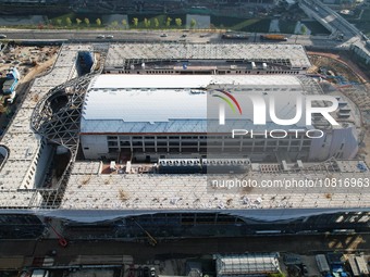 Workers are installing the facade of the experimental building for Zhejiang University's High gravity centrifugal simulation and experimenta...