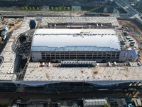 Workers are installing the facade of the experimental building for Zhejiang University's High gravity centrifugal simulation and experimenta...