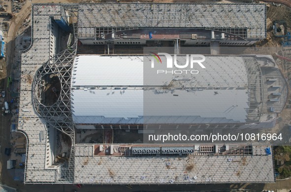 Workers are installing the facade of the experimental building for Zhejiang University's High gravity centrifugal simulation and experimenta...