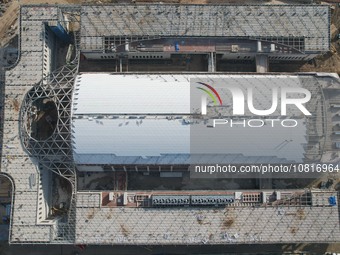 Workers are installing the facade of the experimental building for Zhejiang University's High gravity centrifugal simulation and experimenta...