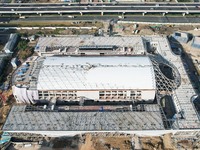 Workers are installing the facade of the experimental building for Zhejiang University's High gravity centrifugal simulation and experimenta...