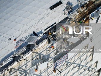 Workers are installing the facade of the experimental building for Zhejiang University's High gravity centrifugal simulation and experimenta...