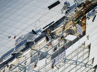 Workers are installing the facade of the experimental building for Zhejiang University's High gravity centrifugal simulation and experimenta...