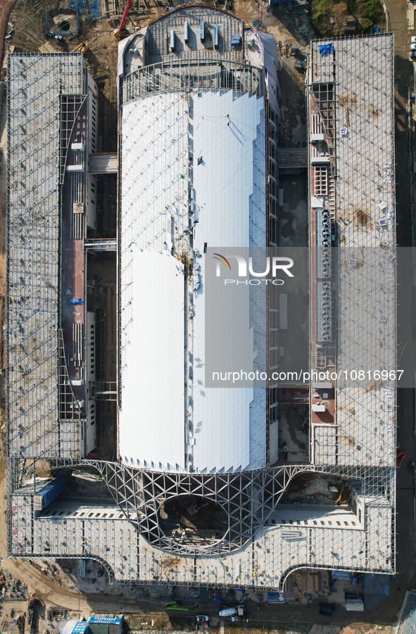 Workers are installing the facade of the experimental building for Zhejiang University's High gravity centrifugal simulation and experimenta...