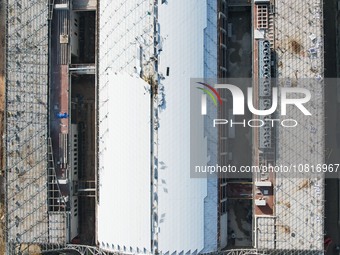 Workers are installing the facade of the experimental building for Zhejiang University's High gravity centrifugal simulation and experimenta...