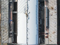 Workers are installing the facade of the experimental building for Zhejiang University's High gravity centrifugal simulation and experimenta...