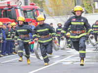 Firefighters are conducting a fire drill at the Qianyuan fire prevention and rescue station in Deqing County, Huzhou City, Zhejiang Province...