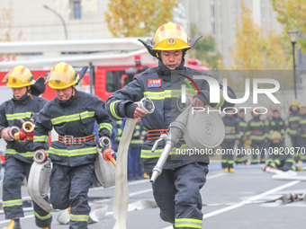 Firefighters are conducting a fire drill at the Qianyuan fire prevention and rescue station in Deqing County, Huzhou City, Zhejiang Province...