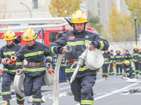 Firefighters are conducting a fire drill at the Qianyuan fire prevention and rescue station in Deqing County, Huzhou City, Zhejiang Province...