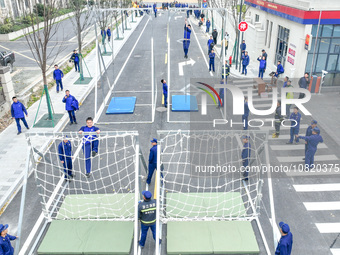 Firefighters are conducting a fire drill at the Qianyuan fire prevention and rescue station in Deqing County, Huzhou City, Zhejiang Province...