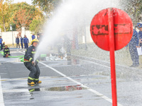 Firefighters are conducting a fire drill at the Qianyuan fire prevention and rescue station in Deqing County, Huzhou City, Zhejiang Province...