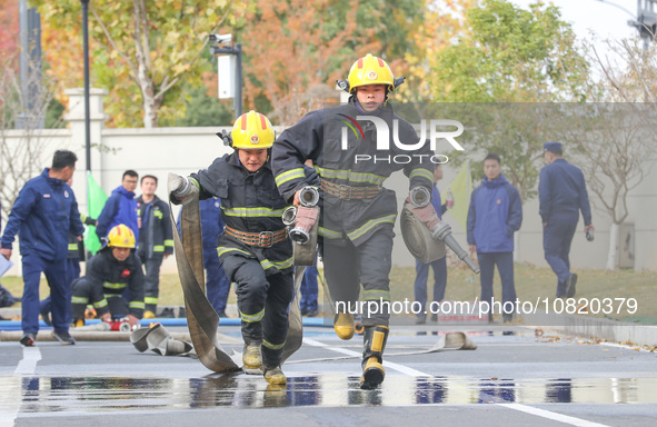 Firefighters are conducting a fire drill at the Qianyuan fire prevention and rescue station in Deqing County, Huzhou City, Zhejiang Province...