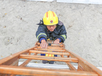 Firefighters are conducting a fire drill at the Qianyuan fire prevention and rescue station in Deqing County, Huzhou City, Zhejiang Province...