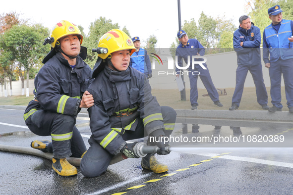 Firefighters are conducting a fire drill at the Qianyuan fire prevention and rescue station in Deqing County, Huzhou City, Zhejiang Province...