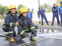 Firefighters are conducting a fire drill at the Qianyuan fire prevention and rescue station in Deqing County, Huzhou City, Zhejiang Province...