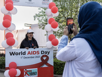 A woman is posing for a photograph in a booth during an event to mark World AIDS Day in Guwahati, Assam, India, on December 1, 2023. (