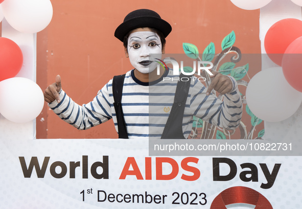 A mime artist is posing for a photograph during an event to mark World AIDS Day in Guwahati, Assam, India, on December 1, 2023. 