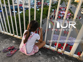 CANCUN, MEXICO - DECEMBER 1, 2023: 
A young girl observes participants of the World AIDS Day March in the center of Cancun, on December 1st,...