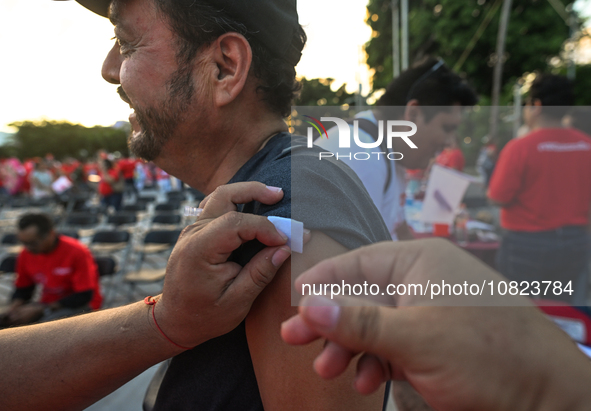 CANCUN, MEXICO - DECEMBER 1, 2023: 
A participant of the World AIDS Day March receives a free anti-virus injection at the end of march, on D...