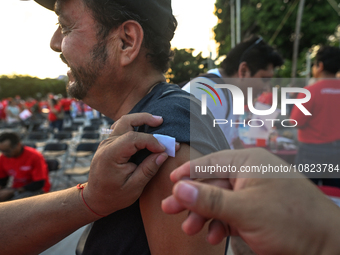 CANCUN, MEXICO - DECEMBER 1, 2023: 
A participant of the World AIDS Day March receives a free anti-virus injection at the end of march, on D...