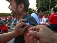 CANCUN, MEXICO - DECEMBER 1, 2023: 
A participant of the World AIDS Day March receives a free anti-virus injection at the end of march, on D...