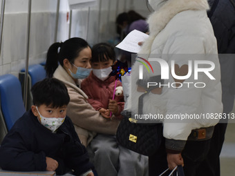 Sick children, accompanied by their parents, are waiting for treatment at the Department of Pediatrics of the People's Hospital in Fuyang Ci...