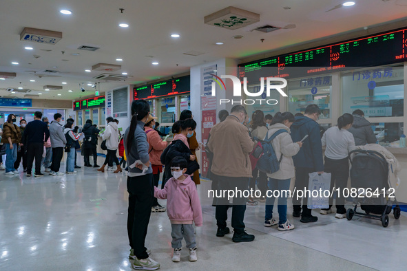 Parents and children with respiratory infectious diseases are waiting to see a doctor at the Children's Hospital in Chongqing, China, on Dec...