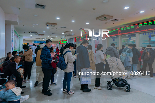 Parents and children with respiratory infectious diseases are waiting to see a doctor at the Children's Hospital in Chongqing, China, on Dec...