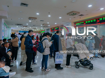 Parents and children with respiratory infectious diseases are waiting to see a doctor at the Children's Hospital in Chongqing, China, on Dec...