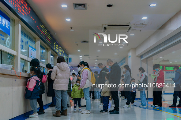 Parents and children with respiratory infectious diseases are waiting to see a doctor at the Children's Hospital in Chongqing, China, on Dec...