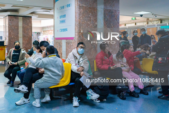 Parents and children with respiratory infectious diseases are waiting to see a doctor at the Children's Hospital in Chongqing, China, on Dec...