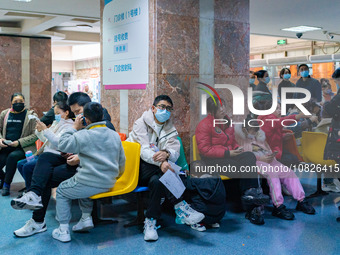 Parents and children with respiratory infectious diseases are waiting to see a doctor at the Children's Hospital in Chongqing, China, on Dec...