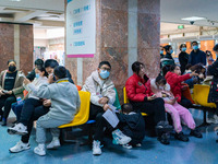 Parents and children with respiratory infectious diseases are waiting to see a doctor at the Children's Hospital in Chongqing, China, on Dec...