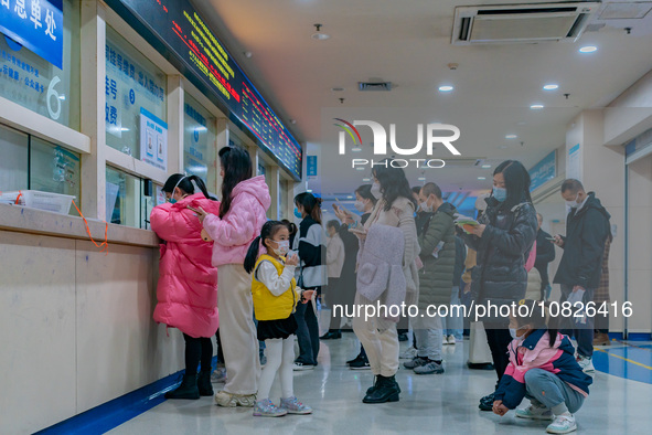 Parents and children with respiratory infectious diseases are waiting to see a doctor at the Children's Hospital in Chongqing, China, on Dec...