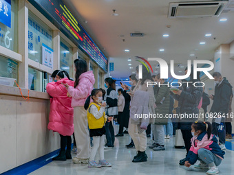 Parents and children with respiratory infectious diseases are waiting to see a doctor at the Children's Hospital in Chongqing, China, on Dec...