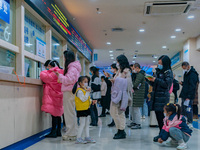 Parents and children with respiratory infectious diseases are waiting to see a doctor at the Children's Hospital in Chongqing, China, on Dec...